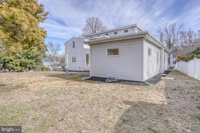 rear view of house with a lawn