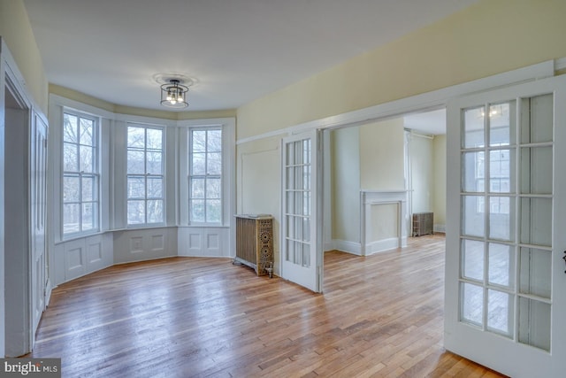 interior space with french doors, plenty of natural light, and light hardwood / wood-style floors