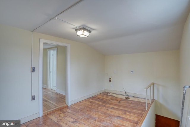 bonus room with lofted ceiling and hardwood / wood-style floors