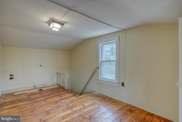 bonus room featuring lofted ceiling and light hardwood / wood-style flooring