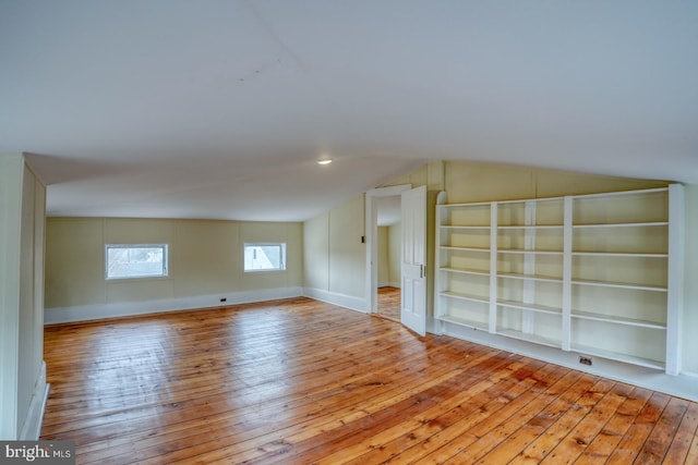 bonus room featuring lofted ceiling and light wood-type flooring