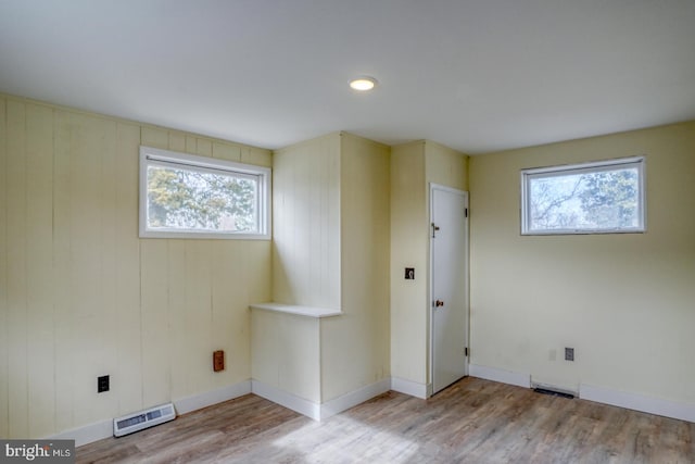 spare room featuring a wealth of natural light and light hardwood / wood-style flooring