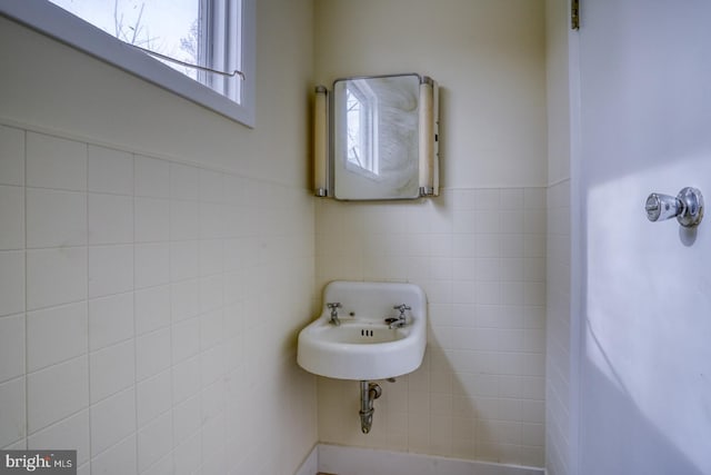 bathroom with tile walls and sink