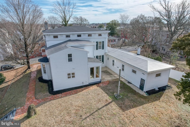 rear view of house featuring a yard