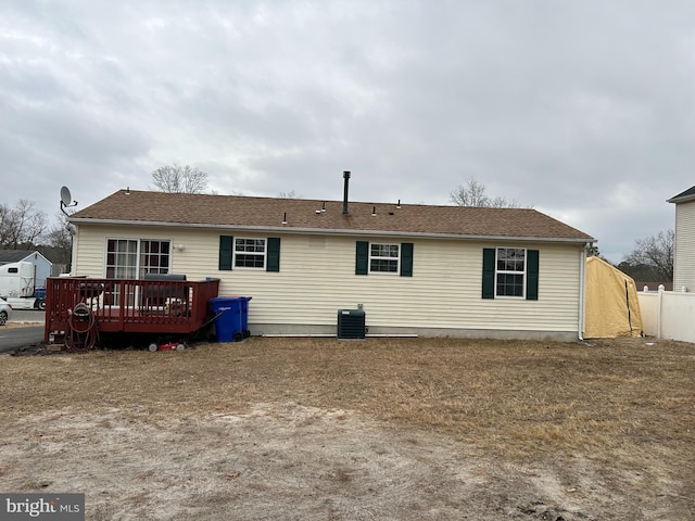 rear view of property featuring cooling unit and a deck