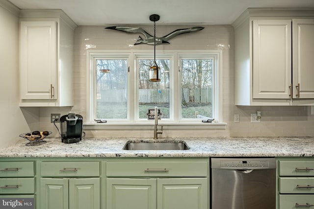 bar featuring pendant lighting, stainless steel dishwasher, sink, and white cabinets