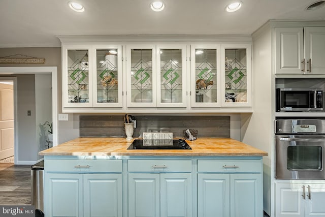 kitchen featuring wood counters, stainless steel appliances, dark hardwood / wood-style floors, and white cabinets