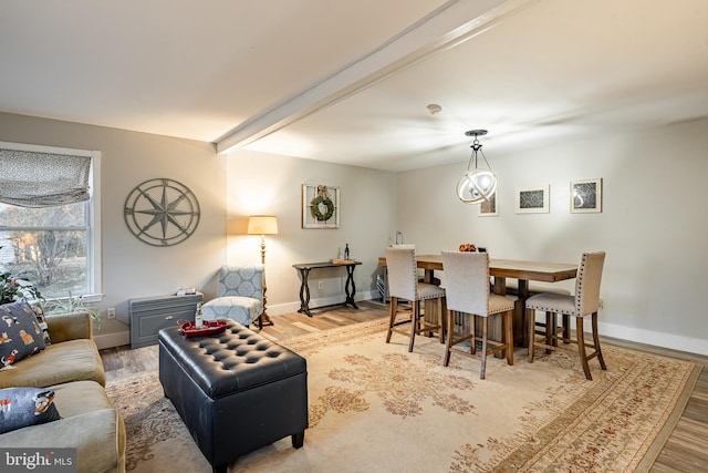 living room featuring beam ceiling and light hardwood / wood-style floors