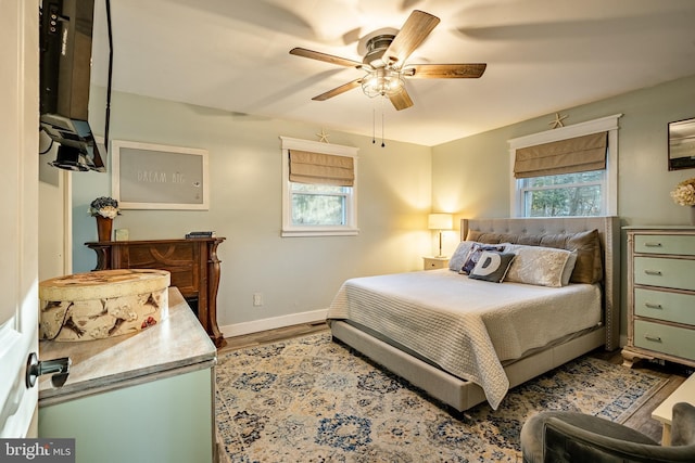 bedroom with ceiling fan and wood-type flooring