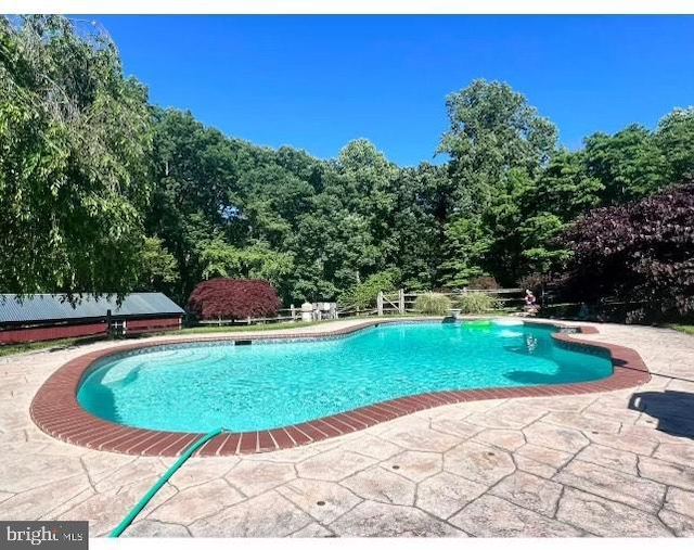 view of swimming pool featuring a patio area