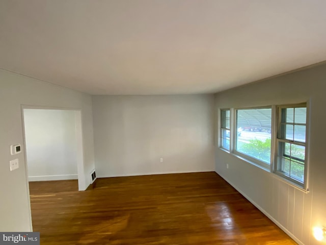 spare room featuring dark hardwood / wood-style floors