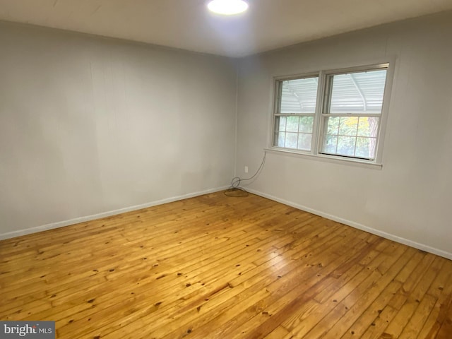 spare room with light hardwood / wood-style flooring