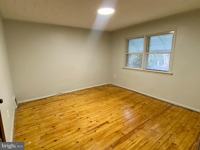 spare room featuring light wood-type flooring