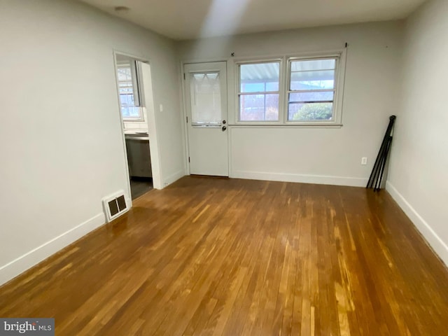 spare room featuring dark wood-type flooring