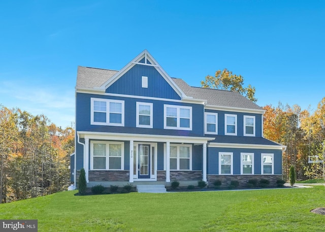 view of front facade featuring a front yard and covered porch