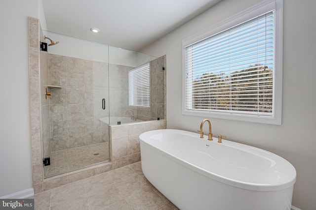 bathroom featuring tile patterned floors and shower with separate bathtub