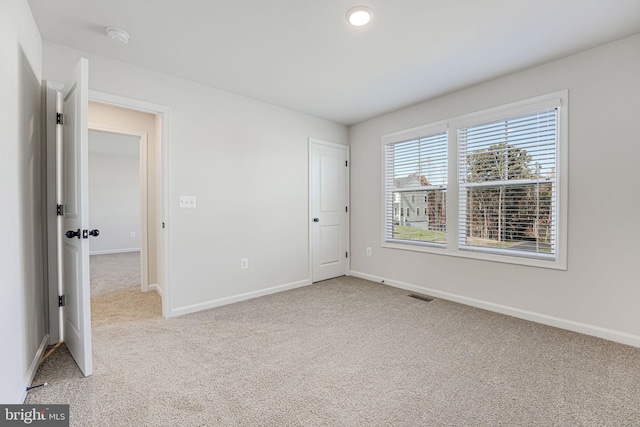 unfurnished bedroom featuring light colored carpet