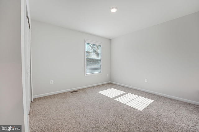 spare room featuring carpet floors