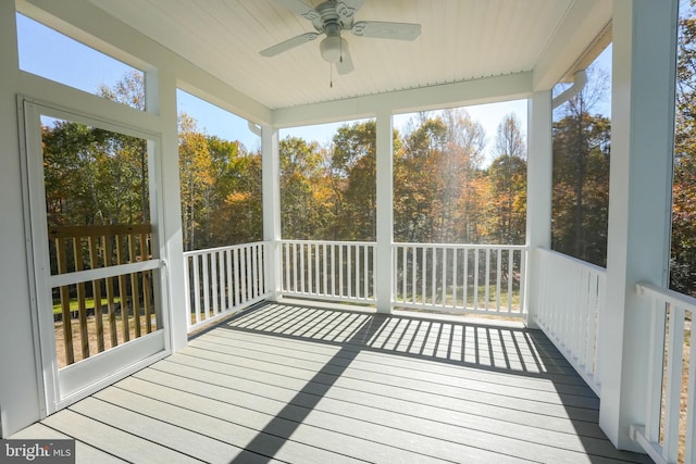 unfurnished sunroom with ceiling fan