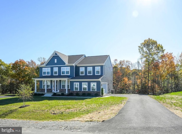 view of front of house featuring a garage and a front yard