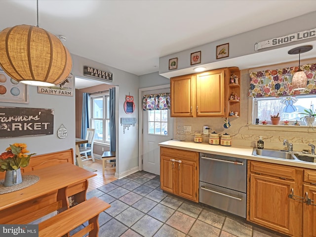 kitchen featuring hanging light fixtures, sink, and decorative backsplash