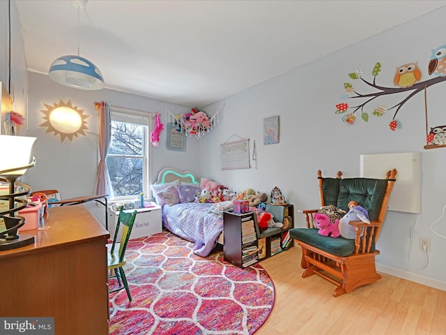 bedroom with hardwood / wood-style flooring