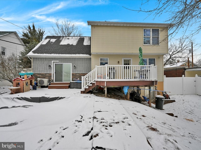 snow covered property featuring a deck