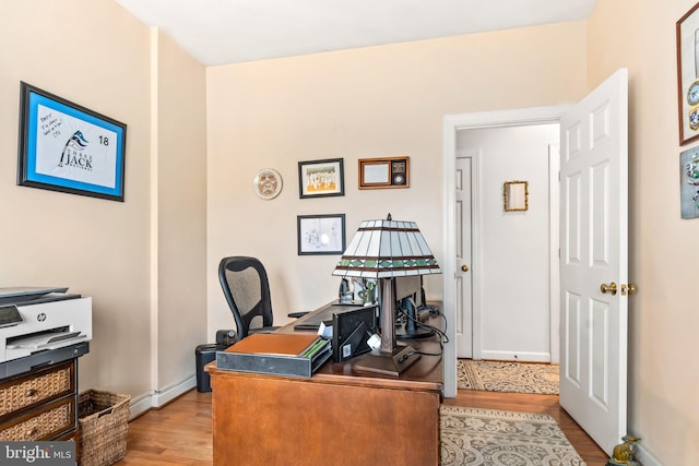 office area with light hardwood / wood-style floors