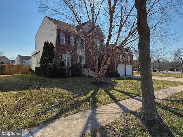 view of front facade featuring a garage and a front lawn