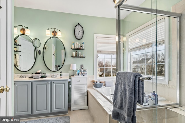 bathroom featuring vanity and separate shower and tub