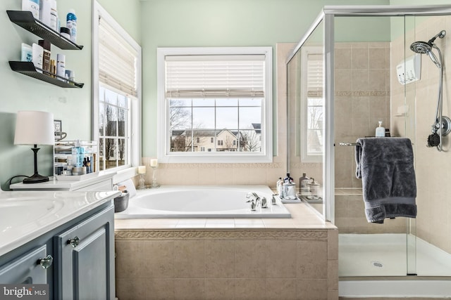 bathroom featuring vanity and separate shower and tub