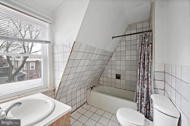 full bathroom featuring tile patterned floors, toilet, shower / tub combo, tile walls, and vanity