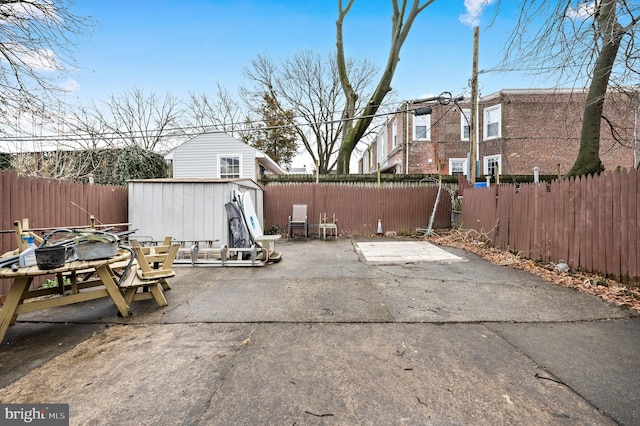 view of patio featuring a storage unit