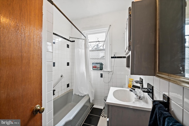 bathroom featuring tile walls, vanity, tile patterned floors, and shower / bath combo with shower curtain