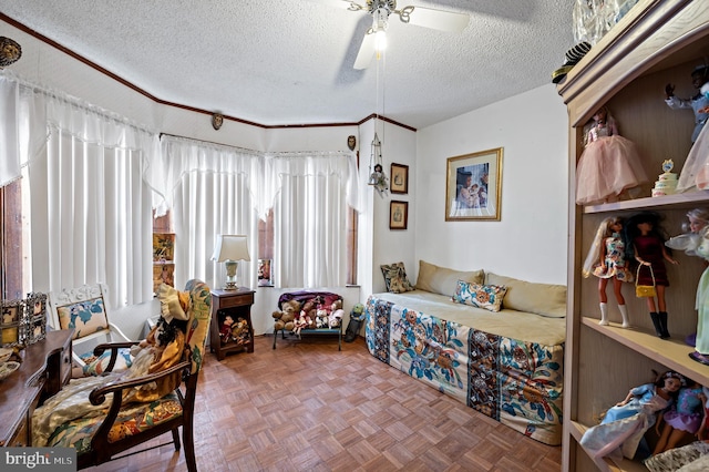 bedroom featuring ceiling fan, parquet flooring, and a textured ceiling