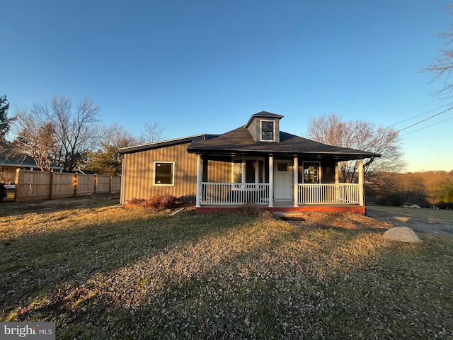 view of front of property with a front yard and covered porch