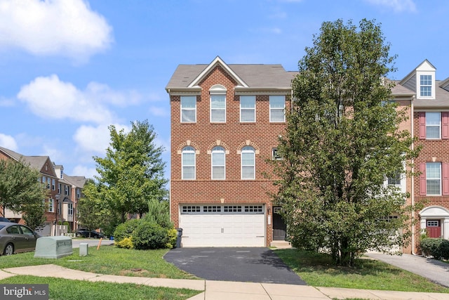 view of property with a garage and a front yard