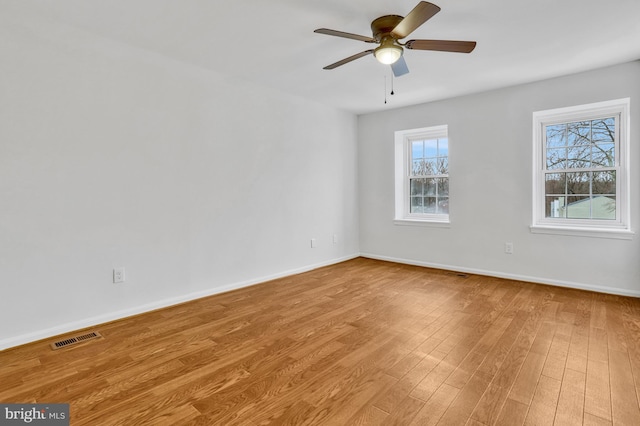 unfurnished room with ceiling fan and light wood-type flooring