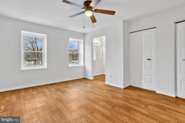 unfurnished bedroom with ceiling fan and light wood-type flooring