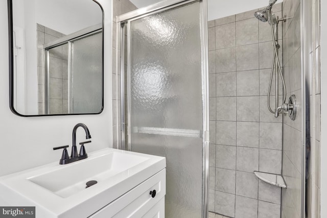 bathroom featuring walk in shower and vanity