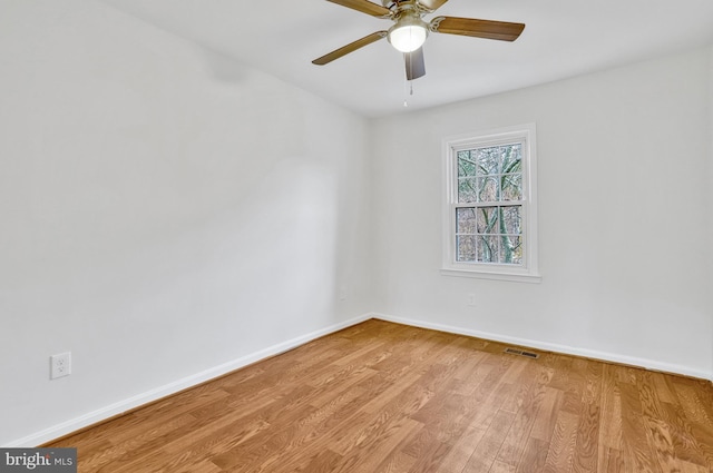 empty room featuring ceiling fan and light hardwood / wood-style flooring