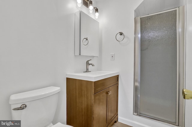 bathroom featuring walk in shower, vanity, and toilet