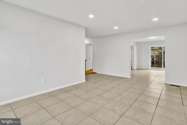 unfurnished room featuring light tile patterned floors