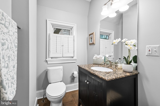 bathroom with vanity, toilet, and tile patterned flooring