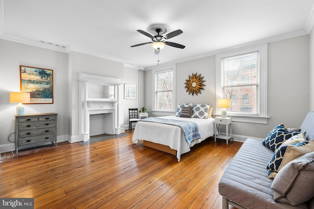 bedroom featuring hardwood / wood-style flooring, ornamental molding, and ceiling fan