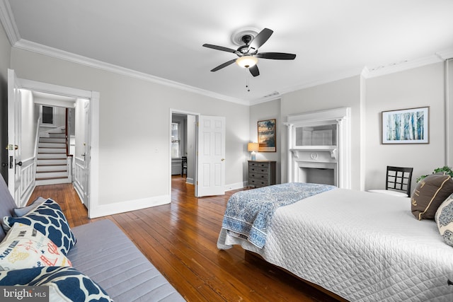 bedroom with ornamental molding, dark wood-type flooring, and ceiling fan