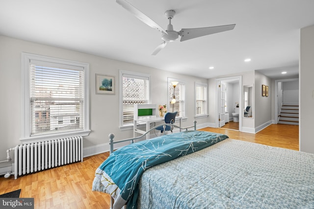 bedroom with ceiling fan, radiator, and hardwood / wood-style floors