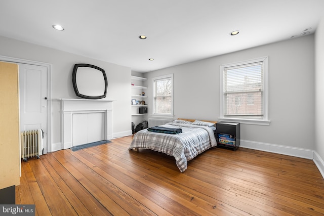 bedroom featuring radiator and hardwood / wood-style floors