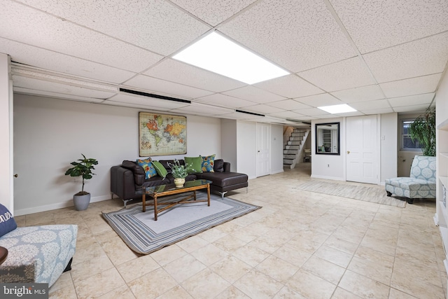 living room featuring a paneled ceiling