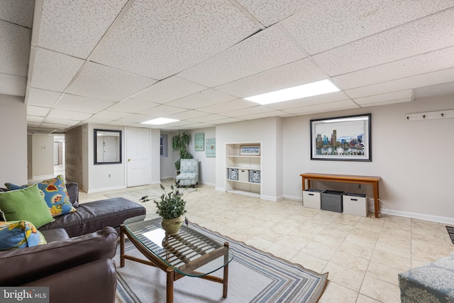 living room featuring a drop ceiling